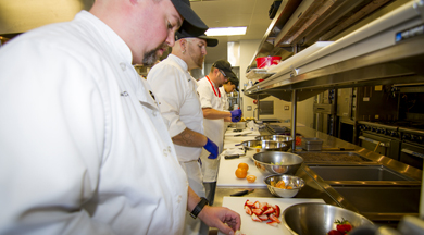 Student chefs cooking in the culinary kitchen.  photo © Robin Spurs